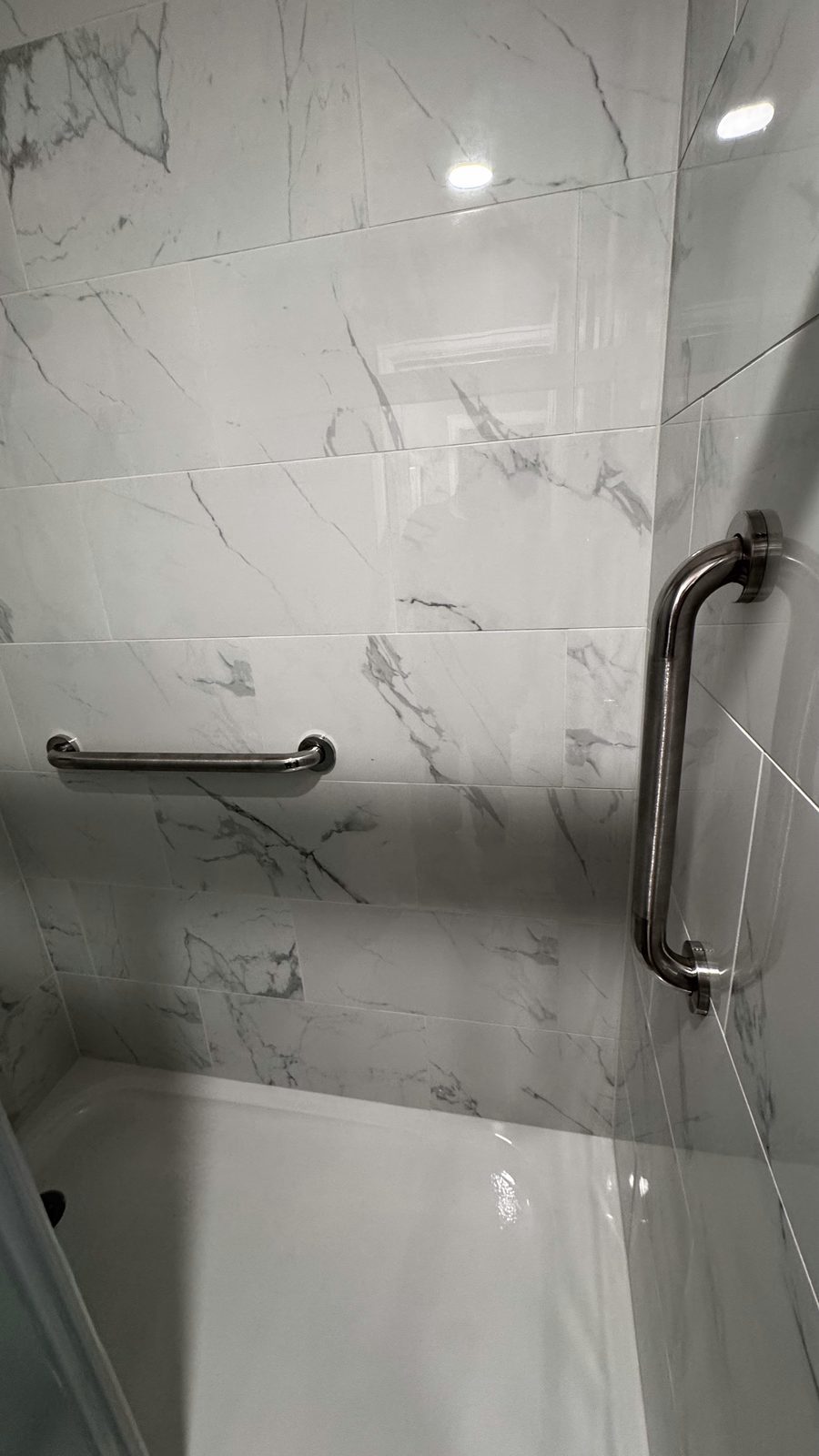Marble tile tub and shower surround with grab bar