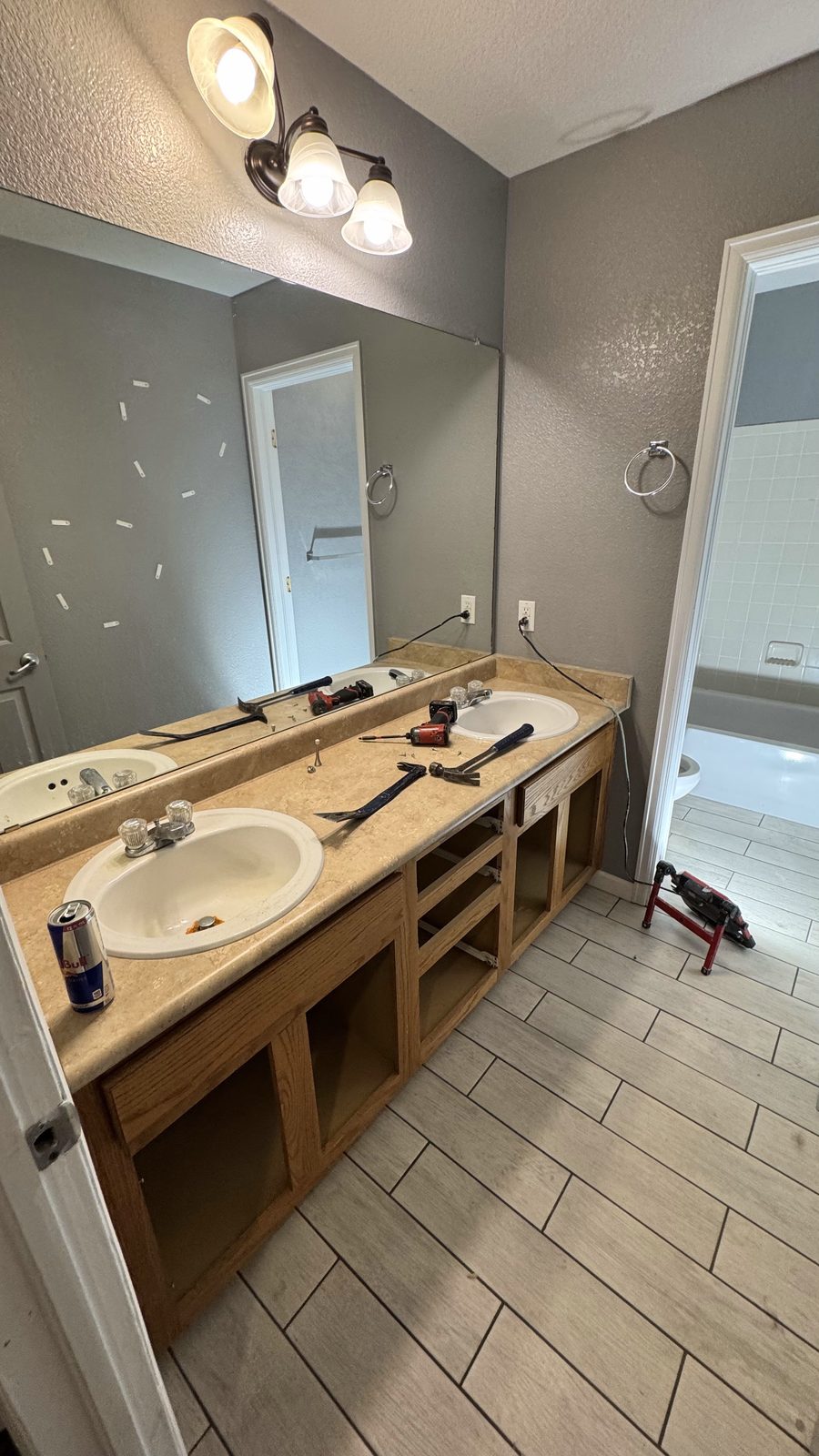 Master bathroom during remodel with unfinished vanity cabinets