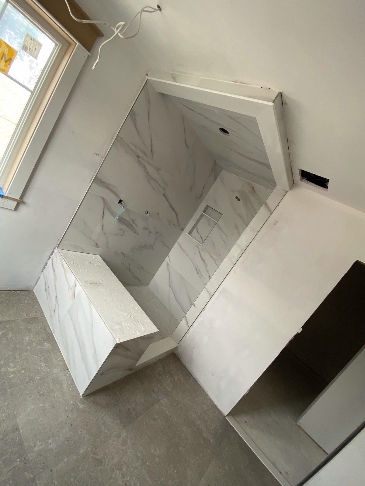 Custom tiled shower with built-in bench seat